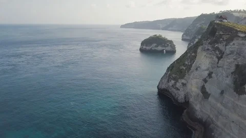 Above the rocky cliff with the ocean view aerial footage of Indonesia Stock Footage 101983444