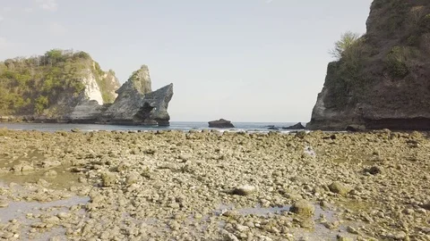 Above the rocky ground with the rocks on the background aerial footage Stock Footage 101994749
