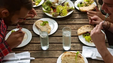 Above shot of healthy multicultural group of young people eating salad,  aerial Stock Footage 199635261