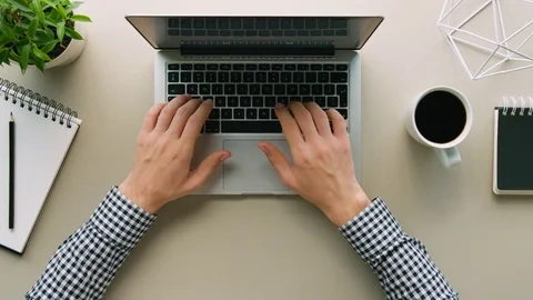 Above shot of man using laptop computer on office table background. Man typing Stock Footage