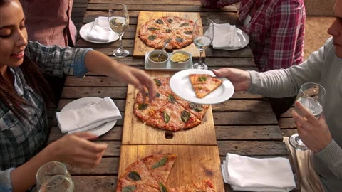 Above shot of  multicultural group of young friends enjoying a meal,  aerial vie Stock Footage 199635214