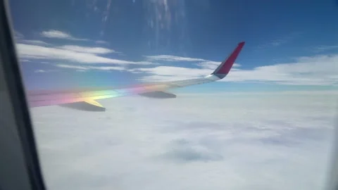 Above sky view of airplane from right wing - 4k Stock Footage 295235199