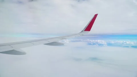 Above sky view of airplane from right wing - 4k Stock Footage 295235200