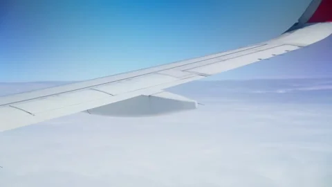 Above sky view of airplane from right wing - 4k Stock Footage 295235201