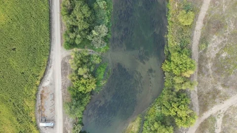Above the Snake River looking down at the blue water and green farm fields Video stock 167856210