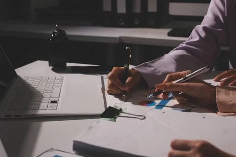 Above table with finance papers, graphs and big data during teamwork meetin.. Stock Photos