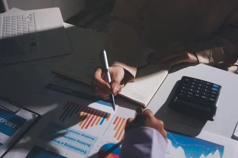 Above table with finance papers, graphs and big data during teamwork meetin.. Stock Photos