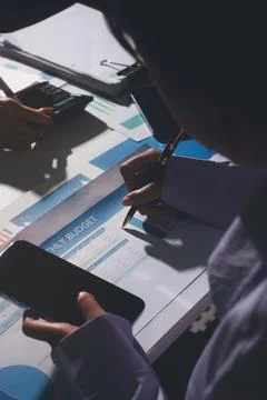Above table with finance papers, graphs and big data during teamwork meetin.. Stock Photos