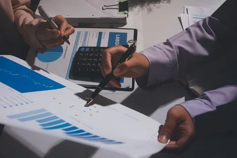 Above table with finance papers, graphs and big data during teamwork meetin.. Stock Photos