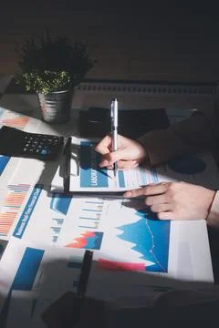 Above table with finance papers, graphs and big data during teamwork meetin.. Stock Photos