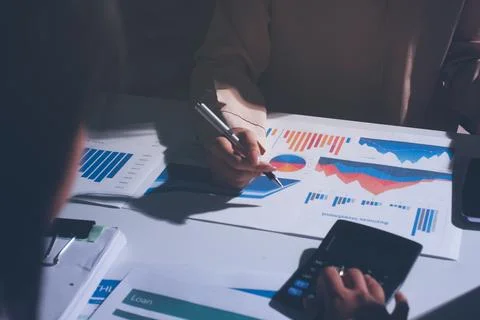 Above table with finance papers, graphs and big data during teamwork meetin.. Stock Photos