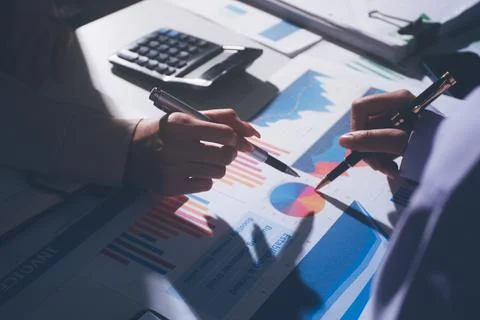 Above table with finance papers, graphs and big data during teamwork meetin.. Stock Photos