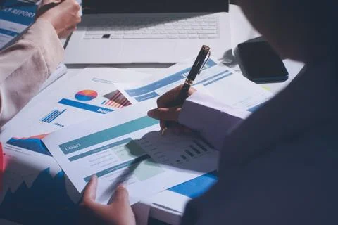 Above table with finance papers, graphs and big data during teamwork meetin.. Stock Photos
