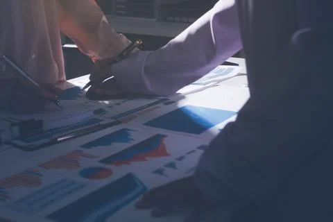 Above table with finance papers, graphs and big data during teamwork meetin.. Stock Photos