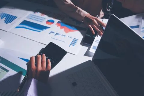 Above table with finance papers, graphs and big data during teamwork meetin.. Stock Photos