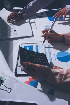 Above table with finance papers, graphs and big data during teamwork meetin.. Stock Photos