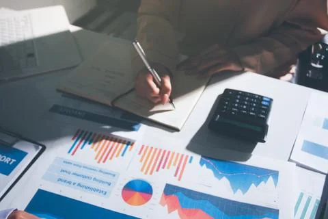 Above table with finance papers, graphs and big data during teamwork meetin.. Stock Photos