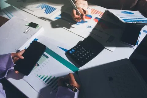 Above table with finance papers, graphs and big data during teamwork meetin.. Stock Photos