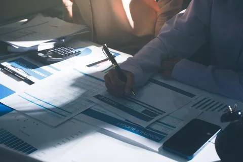 Above table with finance papers, graphs and big data during teamwork meetin.. Stock Photos