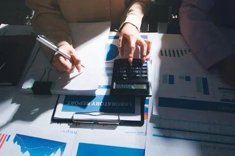 Above table with finance papers, graphs and big data during teamwork meetin.. Stock Photos