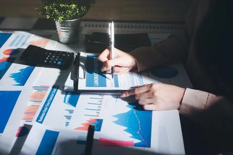 Above table with finance papers, graphs and big data during teamwork meetin.. Stock Photos