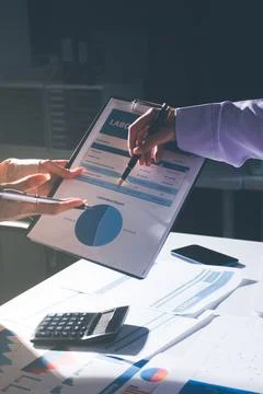 Above table with finance papers, graphs and big data during teamwork meetin.. Stock Photos