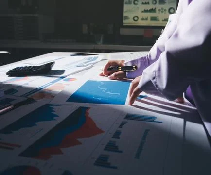 Above table with finance papers, graphs and big data during teamwork meetin.. Stock Photos
