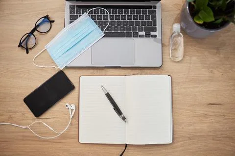 Above, tech and notebook on table for remote work, distance learning and safety Stock Photos