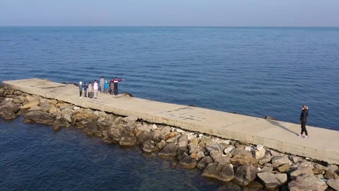 Above top view children training outdoors on the pier by the sea aerial 4K Stock Footage 119263891