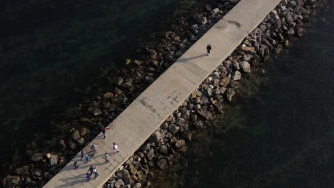 Above top view children training outdoors on the pier by the sea aerial 4K Stock Footage 119263973