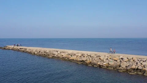 Above top view children training outdoors on the pier by the sea aerial Stock Footage 119264235