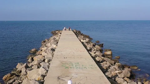 Above top view children training outdoors on the pier by the sea aerial Stock Footage 119264301