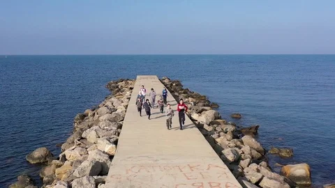 Above top view children training outdoors on the pier by the sea aerial Stock Footage 119264304