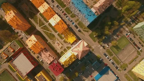 Above top view cozy comfortable colored houses in a European city 4K UHD aerial Stock Footage 75011408