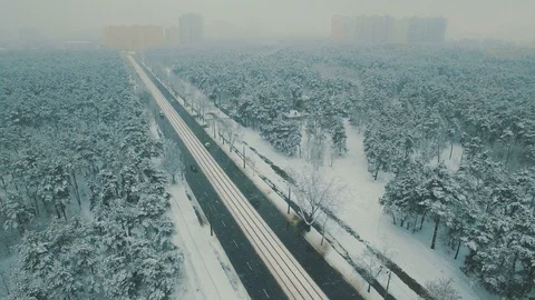 Above top view on winter forest road with cars and tram at snowfall Stock Footage 86156300