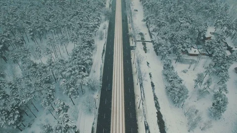 Above top view on winter forest road with cars and tram at snowfall Stock Footage 86156770