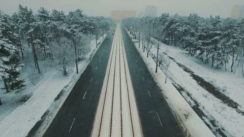 Above top view on winter forest road with cars and tram at snowfall Stock Footage 86156837