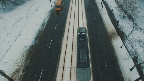 Above top view on winter forest road with cars and tram at snowfall Stock Footage 86157023