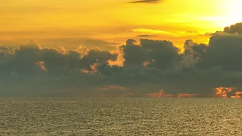 From above, the tropical sea glows under the fiery golden sunset. Stock Footage 308054635