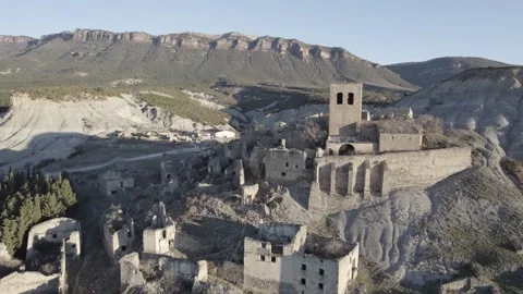 From above view of ancient stone castle located on mountain slope against Stock Footage 264181082