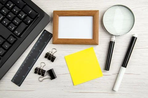 Above view of brown empty picture frame and half shot laptop ruler marker m.. Stock Photos