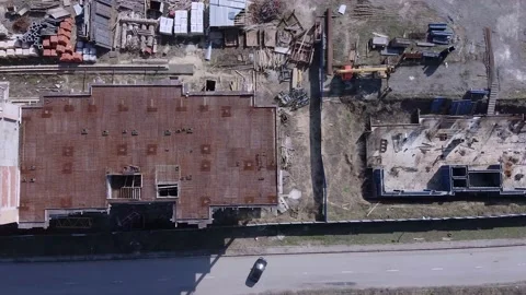 Above view onto construction site with working crane and unfinished buildings Stock Footage 130586070