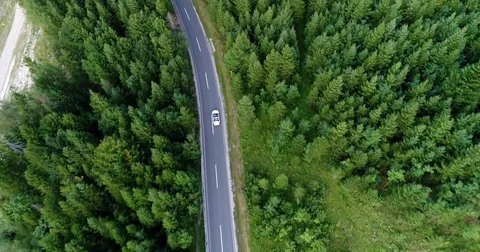 Above view from copter at the car driving along the road in Austria. Stock Footage 82243333