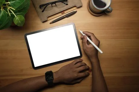 Above view of creative man hand holding stylus pen and using digital tablet.. Foto stock