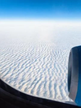 Above view of dense clouds through porthole Stock Photos