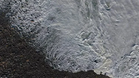 Above View Of Foamy Waves Over Sandy Shoreline. Aerial Topdown Stock-Footage 256771172