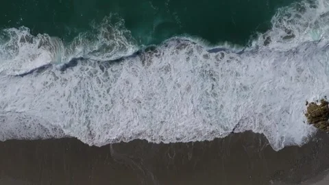 Above View Of Foamy Waves Onto Seacoast Stock Footage 277531067