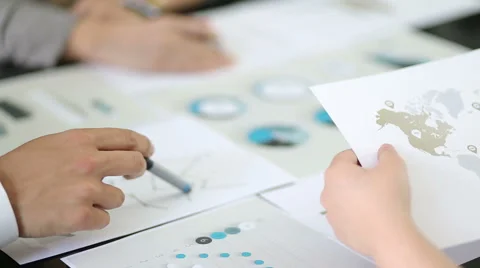 Above view  graphic data templates on table with unrecognizable business people Stock Footage 54588892