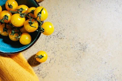 Above view of heirloom cherry tomatoes with yellow towel.. Stock Photos