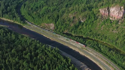 Above view of long freight train of Russian Railways RZD moving among scenery 스톡 동영상 254949399
